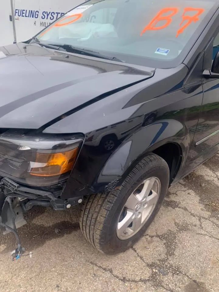 Donor minivan with its bumper removed at The New Country Auto Parts -- panels stay in play, wear items and airbags do not get resold