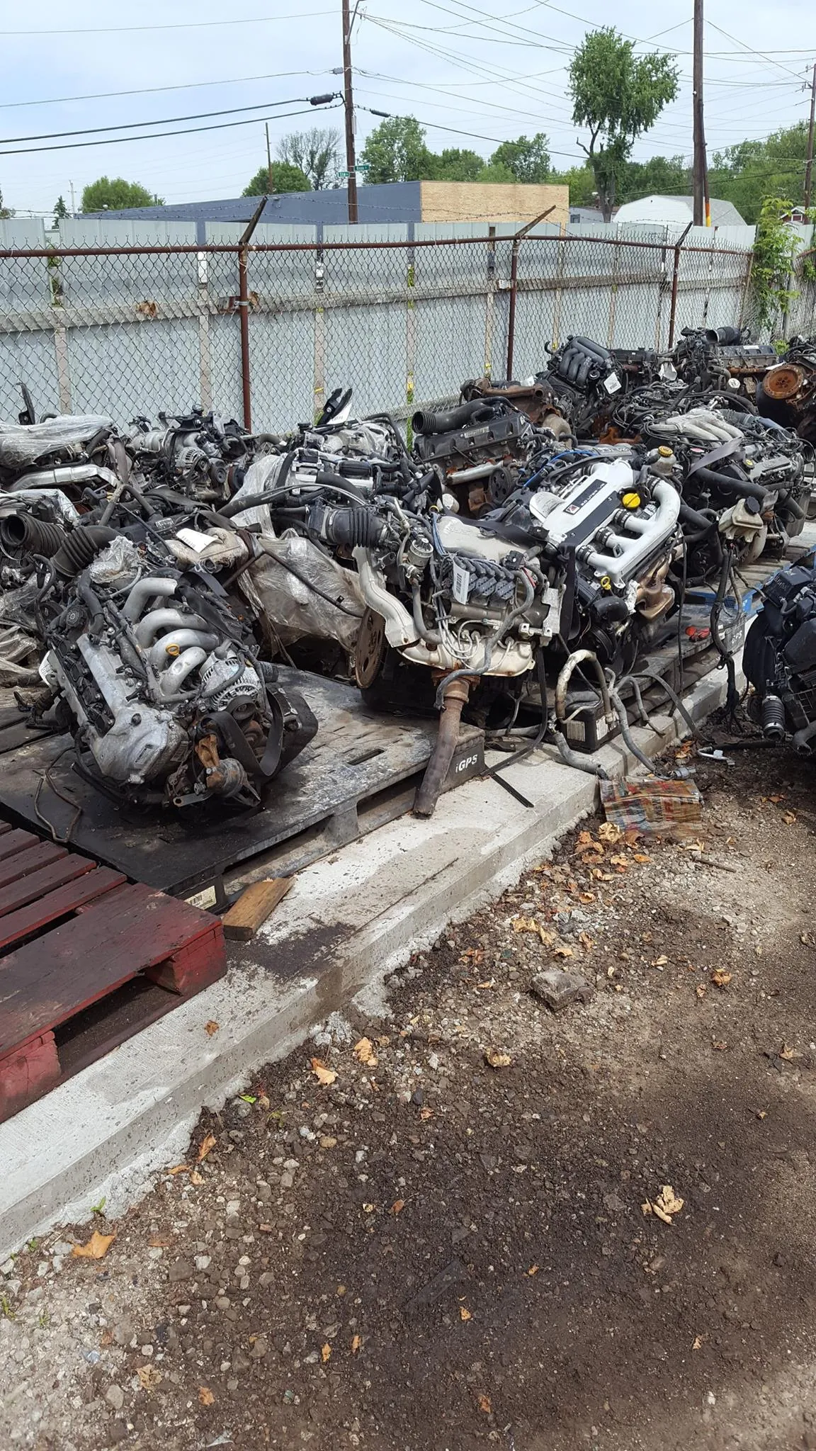 Pile of used automobile engines at an Indianapolis salvage yard, priced by size and demand