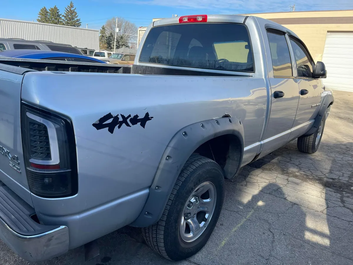 Silver Dodge Ram 1500 4x4 in the salvage yard awaiting parts evaluation