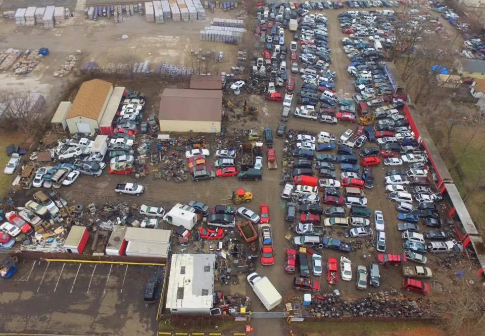 Salvage inventory stretching across the south-side lot at The New Country Auto Parts, where staff pull and stage parts daily